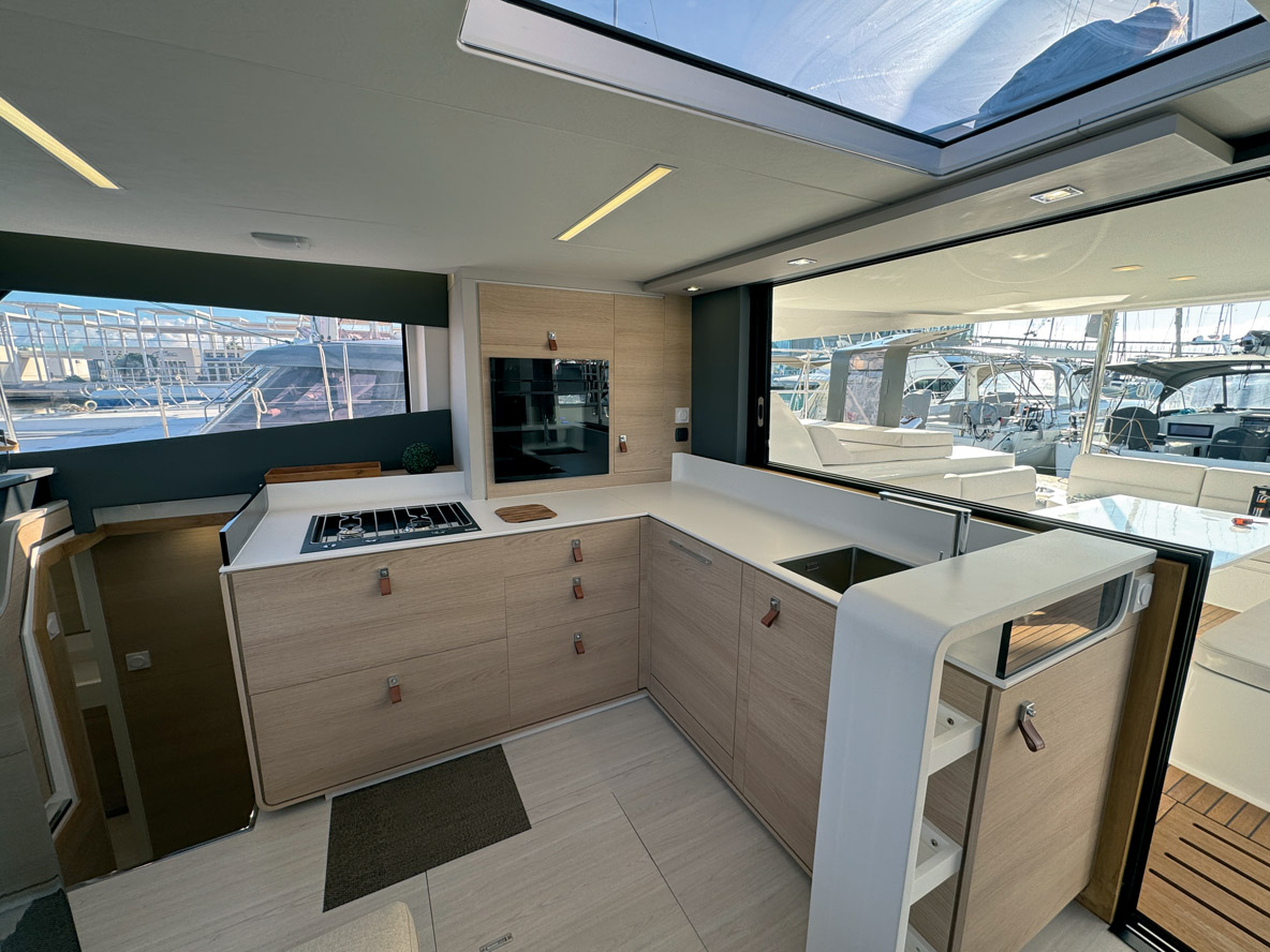 Disposée en L contre le cockpit, la cuisine peut s’ouvrit complètement sur l’extérieur.