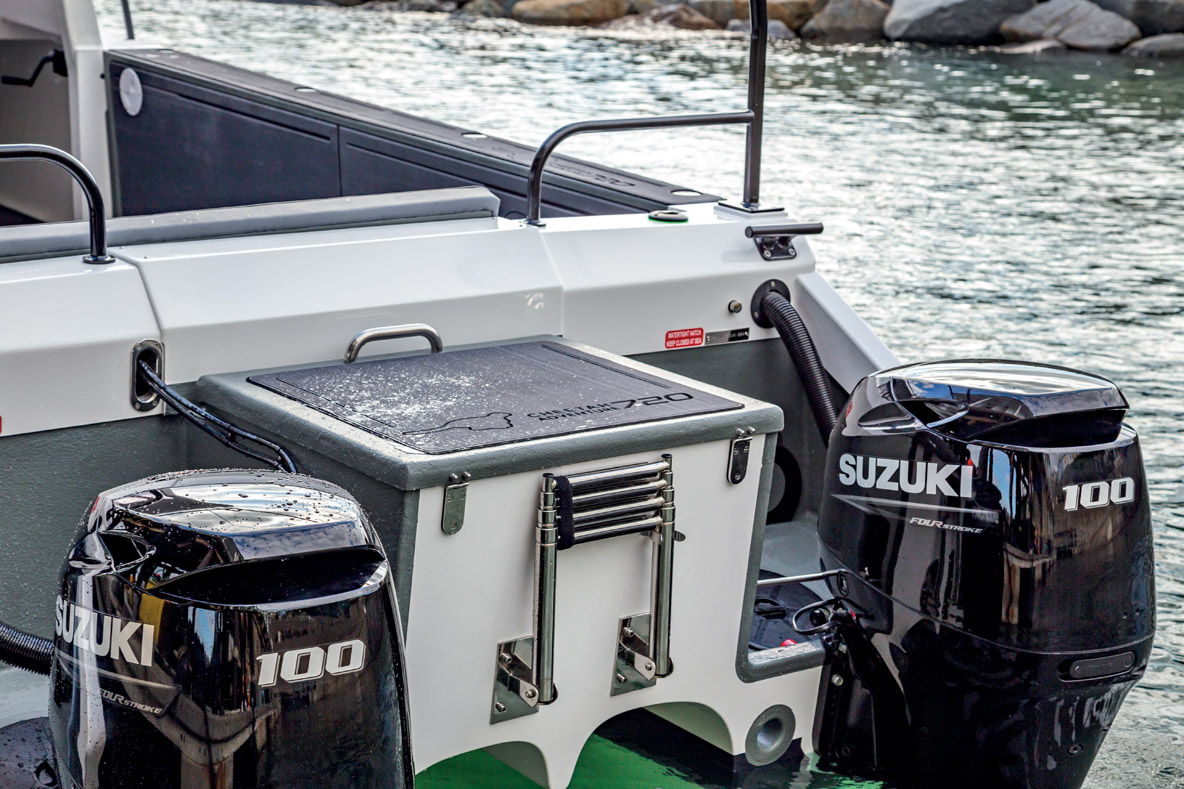 Between the two outboards, a large exterior storage  area doubles as a raised aft deck.