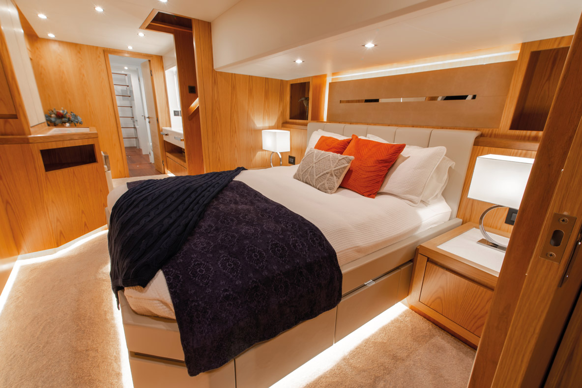 The spacious owner’s suite uses the entire port hull, with queen island bed and walk-in wardrobe aft to buffer engine noise.