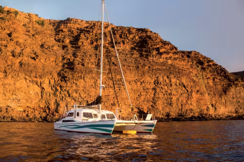 Ceilydh, our catamaran at anchor beneath the cliffs at the anchorage in St Helena.