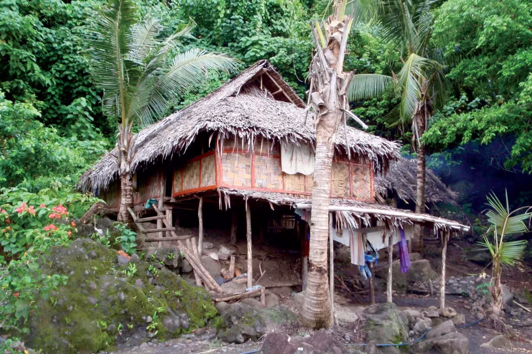 A hut on stilts, facing the sea.